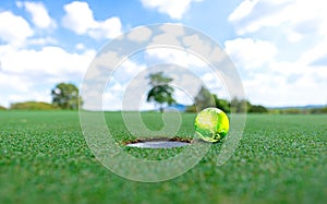 Green earth golf on a green put blue sky background. World golf.