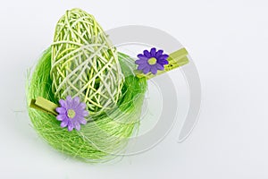 Green Easter Egg in green nest with grey background