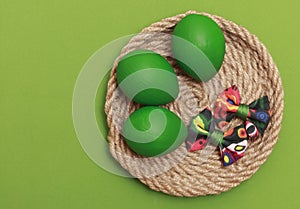 Green Easter eggs with colorful bow.