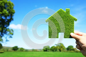 Green ecological house in empty field