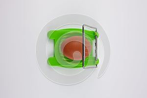 Green egg cutter with a boiled egg