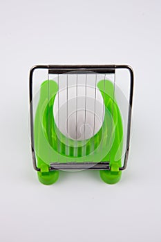 Green egg cutter with a boiled egg