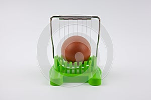 Green egg cutter with a boiled egg