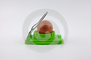 Green egg cutter with a boiled egg