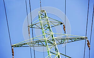 Green electricity pole with black wires