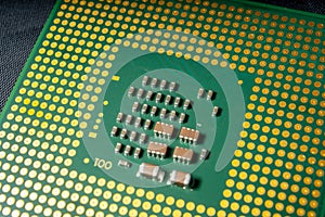 Green electronic chip CPU closeup. Concept of high technology and repair microchip