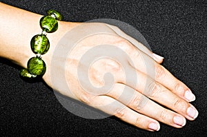 Green emerald bracelet on woman hand