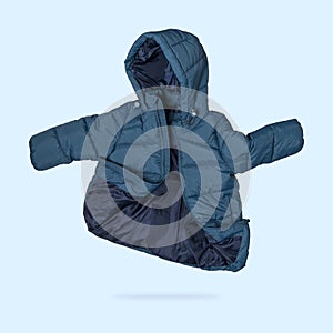 Green emerald flying children`s winter autumn jacket with hood isolated on blue background. Waterproof jacket for child, warm dow