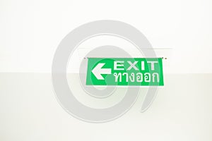 Green emergency exit sign green light box. Thai Letter is Thai Language mean EXIT