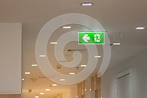 The green emergency exit sign in hospital showing the way to escape