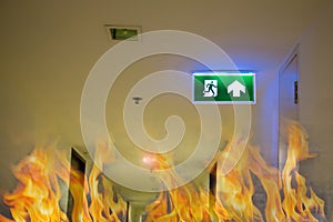 Green emergency exit sign showing the way to escape.Fire exit in the building.