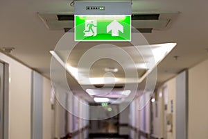 Green emergency exit sign showing the way to escape.Fire exit in the building