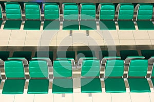 Green empty seats at an airport waiting area. High angle view