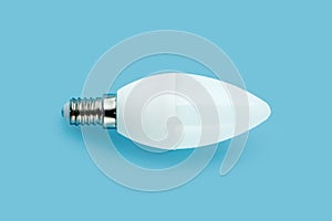 Green energy concept. Led lamp isolated on blue background