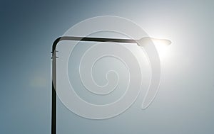 Green energy. Concept photo illustrating the sun as a street lighting lamp.