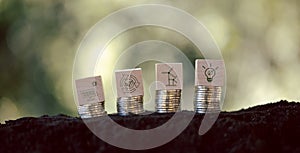 Green energy icons on wooden cubes with stack money coin. Green business growth. Finance sustainable development. growing money,