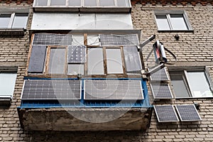 Green energy from solar panels on the balcony and wall in a multi-storey building gives free electricity to a separate apartment