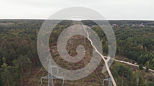 Green energy sustainability and renewable concept. Tower of power lines in the forest. Electric tower lines surrounded by green pi