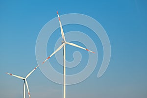 Green energy.Wind generator on blue sky background.Natural energy.Windmill on sky background. renewable energy.