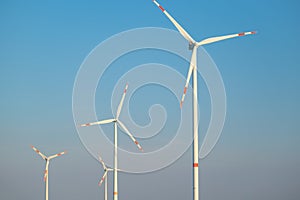 Green energy.Wind generator on blue sky background.Natural energy.Windmill on sky background. renewable energy