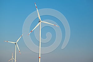 Green energy.Wind generator on blue sky background.Windmill on sky background. renewable energy.Environmentally friendly