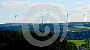 Green energy.Wind generator silhouettes on the green hills.Windmill set background. Environmentally friendly natural