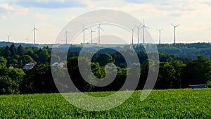 Green energy.Wind generator silhouettes on the green hills.Windmill set background. renewable energy.Environmentally