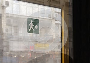 Green exit sign on the bus door