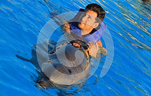 Green eyes man swimming with a gorgeous dolphin flipper smiling face happy kid swim bottle nose dolphins