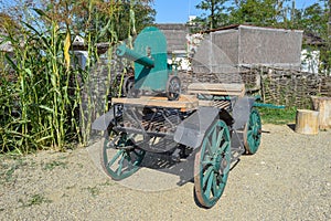 Green fake ancient gun on a cart