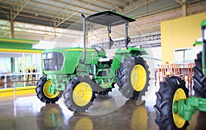 Green farm tractor in the sales office