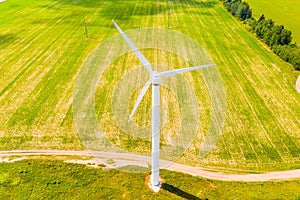 Green farmland concept. Wind turbine in rural area. Aerial landscape