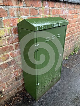 Green fibre communications cabinet on a public pavement