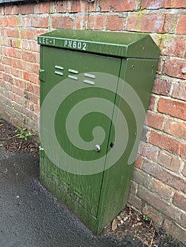 Green fibre communications cabinet on a public pavement