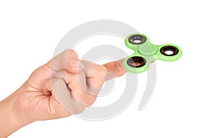 Green fidget spinner in hand isolated on white background