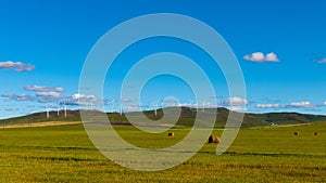 Green field with a cloudy blue sky in the background, perfect for backgrounds and wallpapers