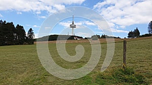 Green field in Hoherodskopf - Vogelsberg under cloudy sky photo