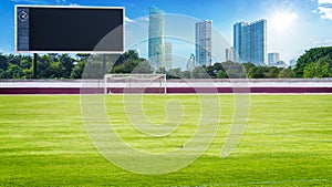 Green field in stadium ans blank scoreboard photo