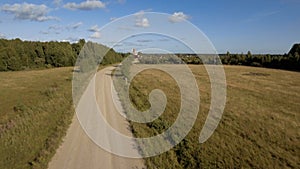 Green field. Stock footage. Huge fields with dry grass next to the road behind which you can see the city and the