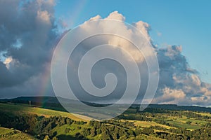 Trees and green field landscape of SÃ£o Miguel island, with clouds and rainbow, Azores PORTUGAL photo