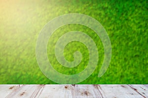 Green field under blue sky. Wood planks floor. Beauty nature background