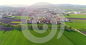 Green fields around a small town. Beautiful European landscape. Small European city aerial view. german village aerial