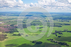 Green fields and forests, blue sky and white clouds background panoramic  aerial view, sunny summer day europe nature landscape