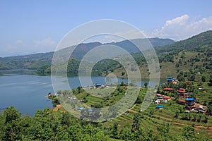 Green fields and lodges at the shore of Lake Begnas