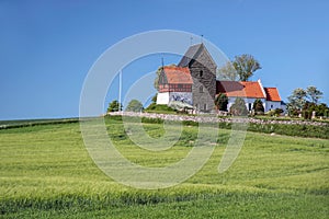 Green fields by the Ruts Kirke church on Bornholm