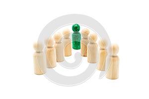 Green figure leading group of wooden figures in spearhead formation, isolated on white background