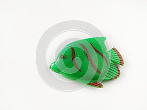 Green Fish toy made from plastic on white background