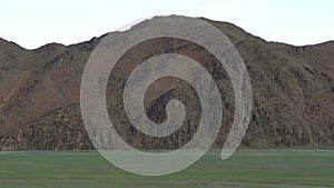 Green Flat Plain Next to Treeless Hills