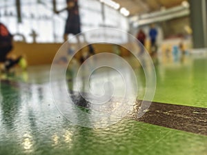 Green floor in school gym in details. Court of Club with lines