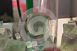 Green Fluorite Natural Octahedron Crystals on glass table